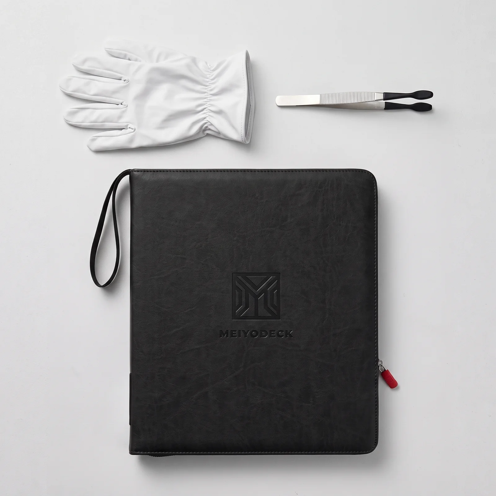 Meiyodeck binder shown with the included white cotton gloves and silicone-tipped tweezers